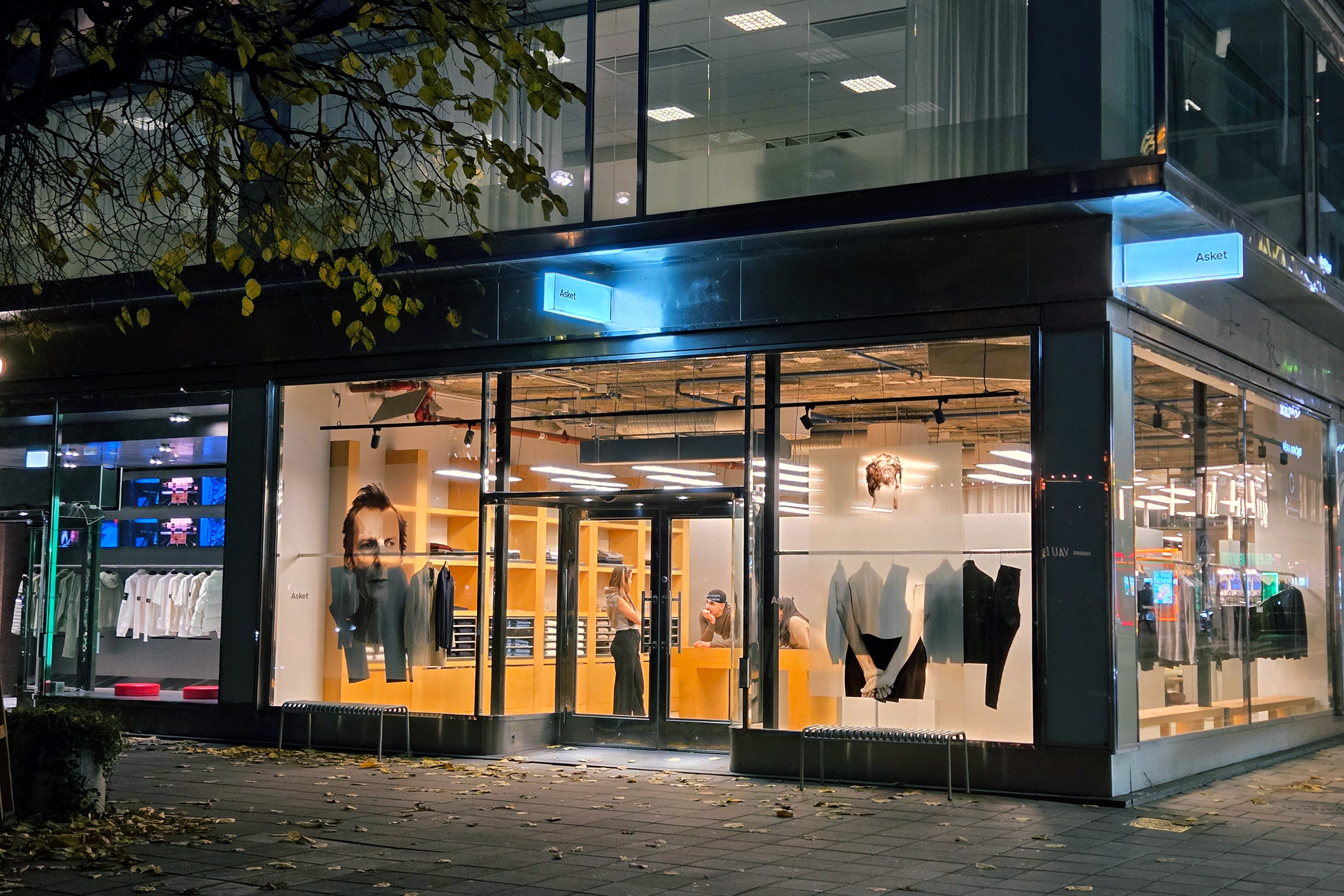 Asket flagship store front lit up at night on Norrmalmstorg