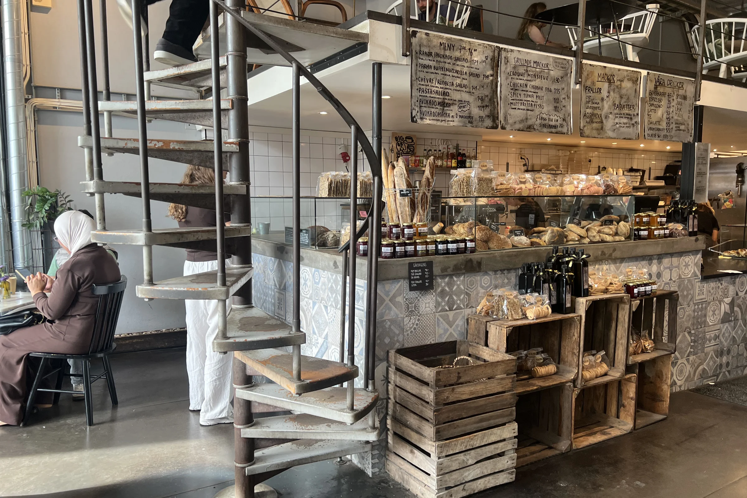 Bullar och bröd bakery in Stockholm with a disk full of buns and bread, and a starircase leading up to the upper floor.