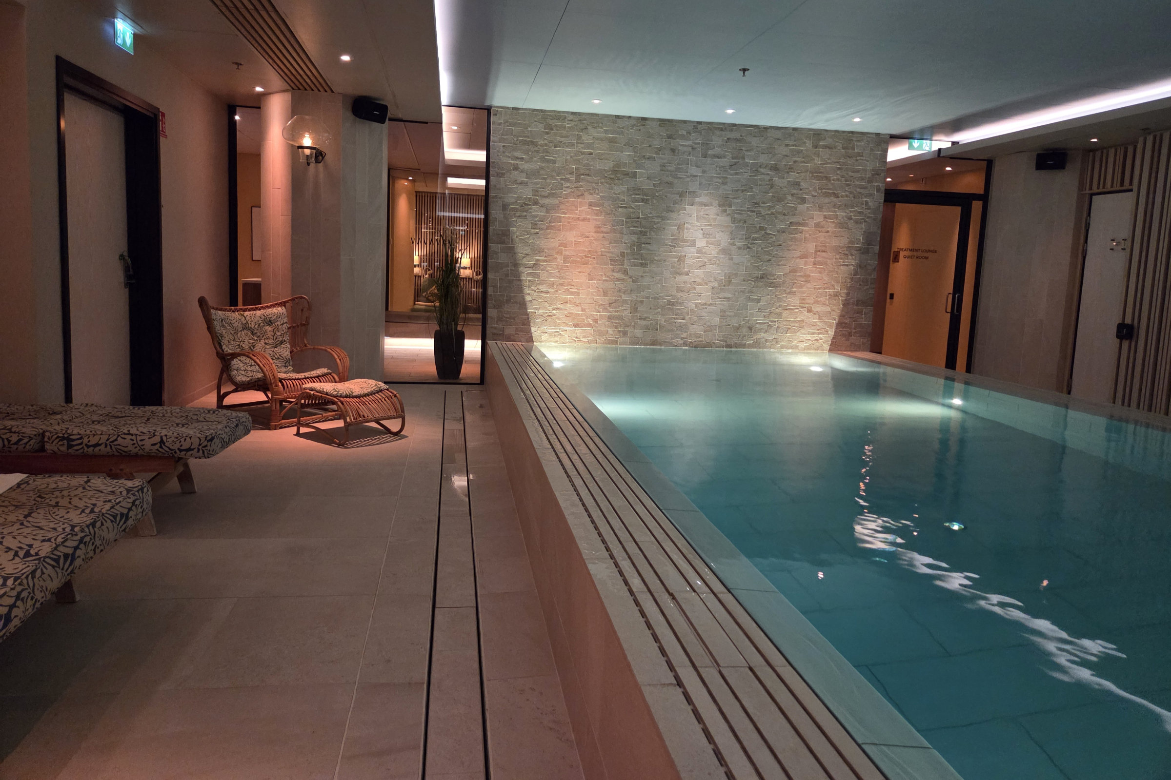 Vana spa interior with pool and chairs.